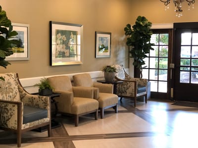 Interior seating area with plants and artwork