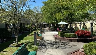 Outdoor area with benches and residents enjoying the sun