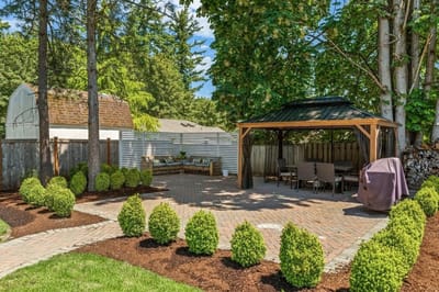 Outdoor patio area with seating and greenery