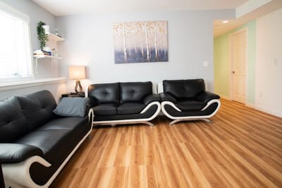 Modern lounge area with black sofas and artwork