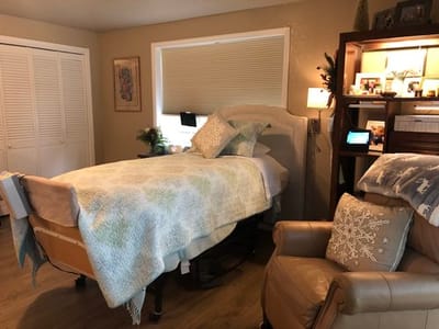 Cozy private room with a large bed and comfortable chair