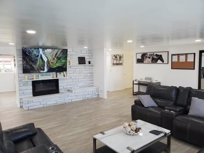 Bright common area with seating and a TV