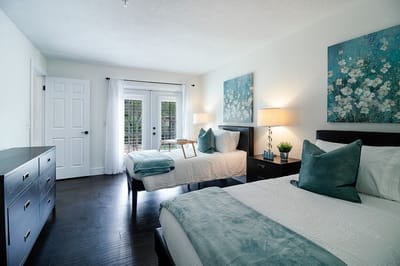 Bright, modern shared bedroom with floral decor