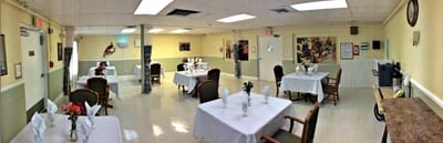 Bright dining area with tables and flowers