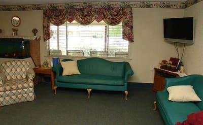 Common area with seating and floral curtains