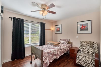 Private resident room with bed and chair
