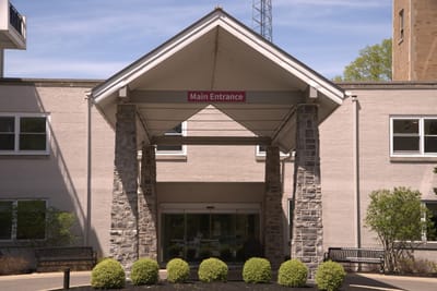 Entrance of a senior living facility with sign