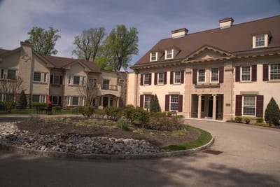 Exterior view of a senior living facility with landscaped grounds