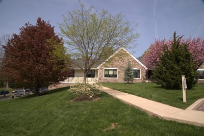 Exterior view of the facility with landscaped grounds