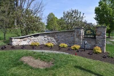 Well-maintained outdoor garden space with a stone wall