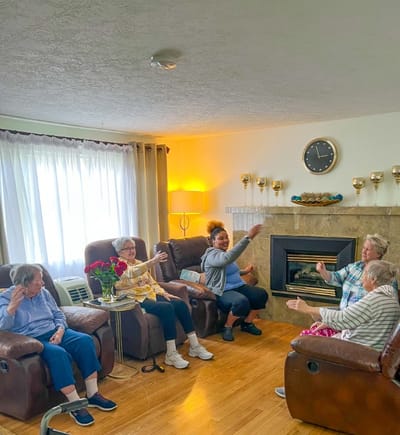 Residents participating in an activity in a cozy common area