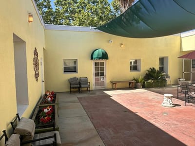 Outdoor courtyard with shaded seating area and plants