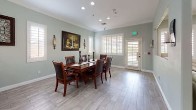 Elegant dining area with a wooden table and chairs.