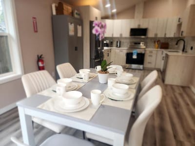 Dining table set with dishes in a bright kitchen