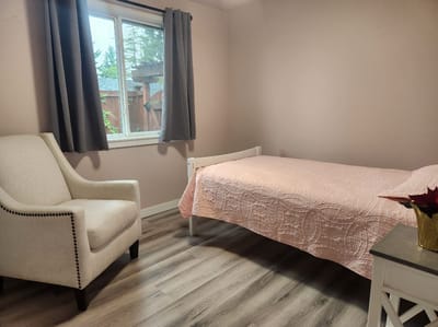 Cozy private resident room with bed and chair