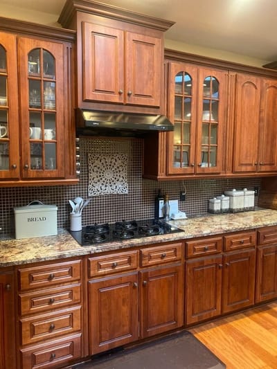 Bright kitchen with wood cabinetry and modern appliances