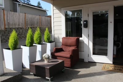 Outdoor seating area with planters and a chair