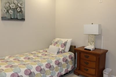 Private bedroom with floral decor and bedside lamp