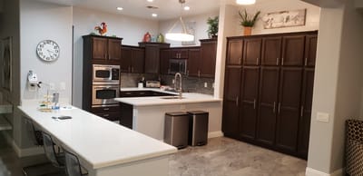Modern kitchen interior with dark cabinets and white countertops