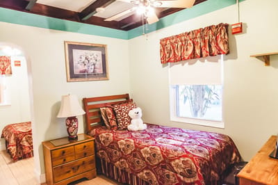 Cozy resident room with a bed, lamp, and decor