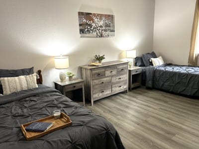 Brightly lit private resident room with twin beds