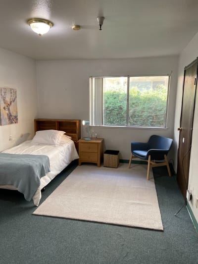 Comfortable resident room with bed and chair