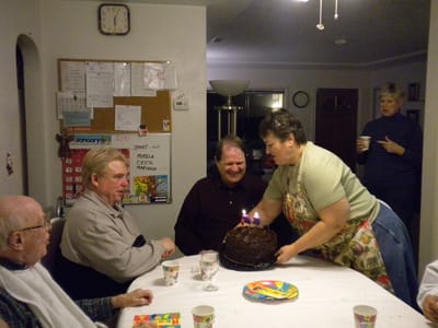 Residents celebrating with cake at a birthday gathering