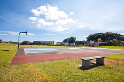 Outdoor basketball court in a sunny landscape