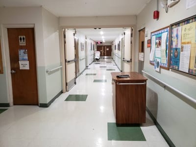 Interior hallway with doors and bulletin boards