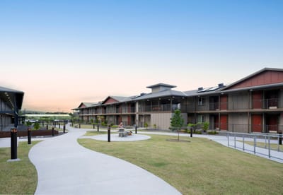 Exterior view of the facility with landscaped pathways