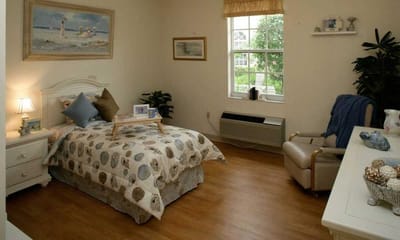 Private resident room with bed and chair