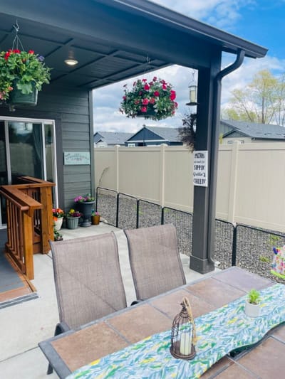 Outdoor seating area with flowers and a fence