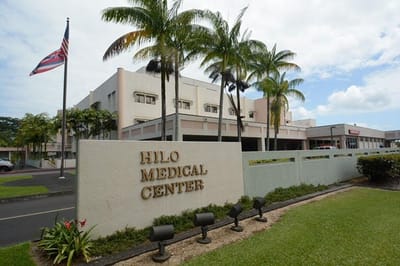 Exterior view of Hilo Medical Center with palm trees