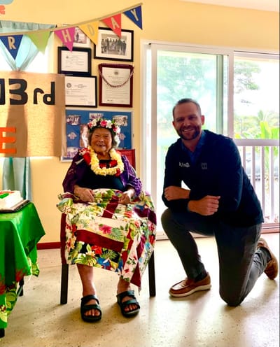 Resident celebrating 103rd birthday with staff