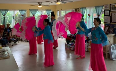 Residents enjoying a cultural performance in the activity room