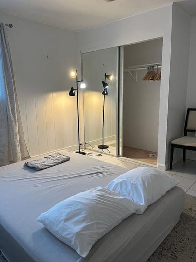 Bright interior room with a bed and lighting fixtures