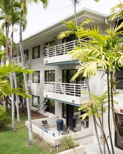 Building exterior with balconies and palm trees