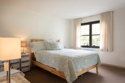 A well-furnished resident bedroom with natural light