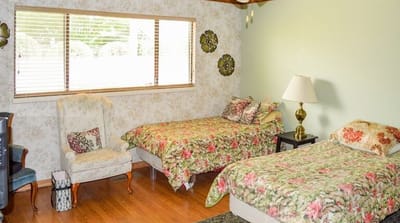 A cozy shared resident room with floral bedding
