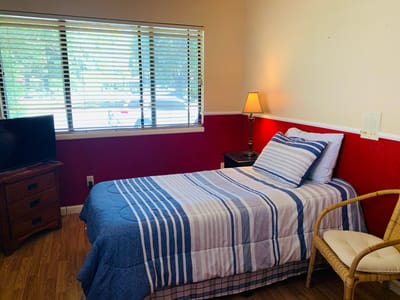 Private resident room with a bed and chair