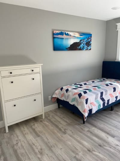 Cozy resident room with bed and dresser