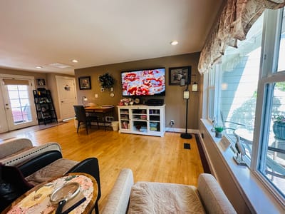 Bright common area with a TV and seating