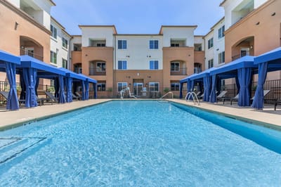 Swimming pool with cabanas at a senior living facility
