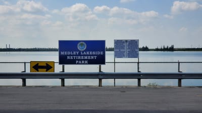 Sign for Medley Lakeside Retirement Park by the water
