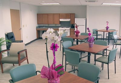 Bright, spacious common area with tables and chairs