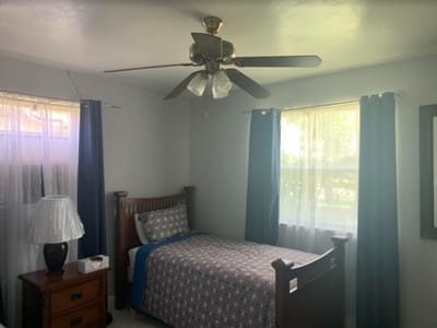 Cozy private resident room with a bed and fan