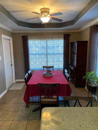 Cozy dining area with a red tablecloth and natural light