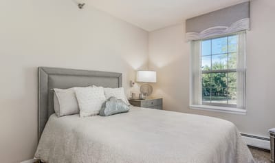 Cozy interior of a resident room with a bed and window