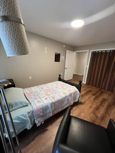 A private resident room with a quilted bedspread