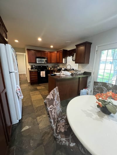 Interior view of a kitchen area with a table and appliances